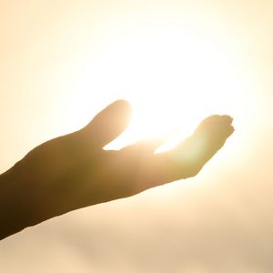 Woman's hand holding the sun